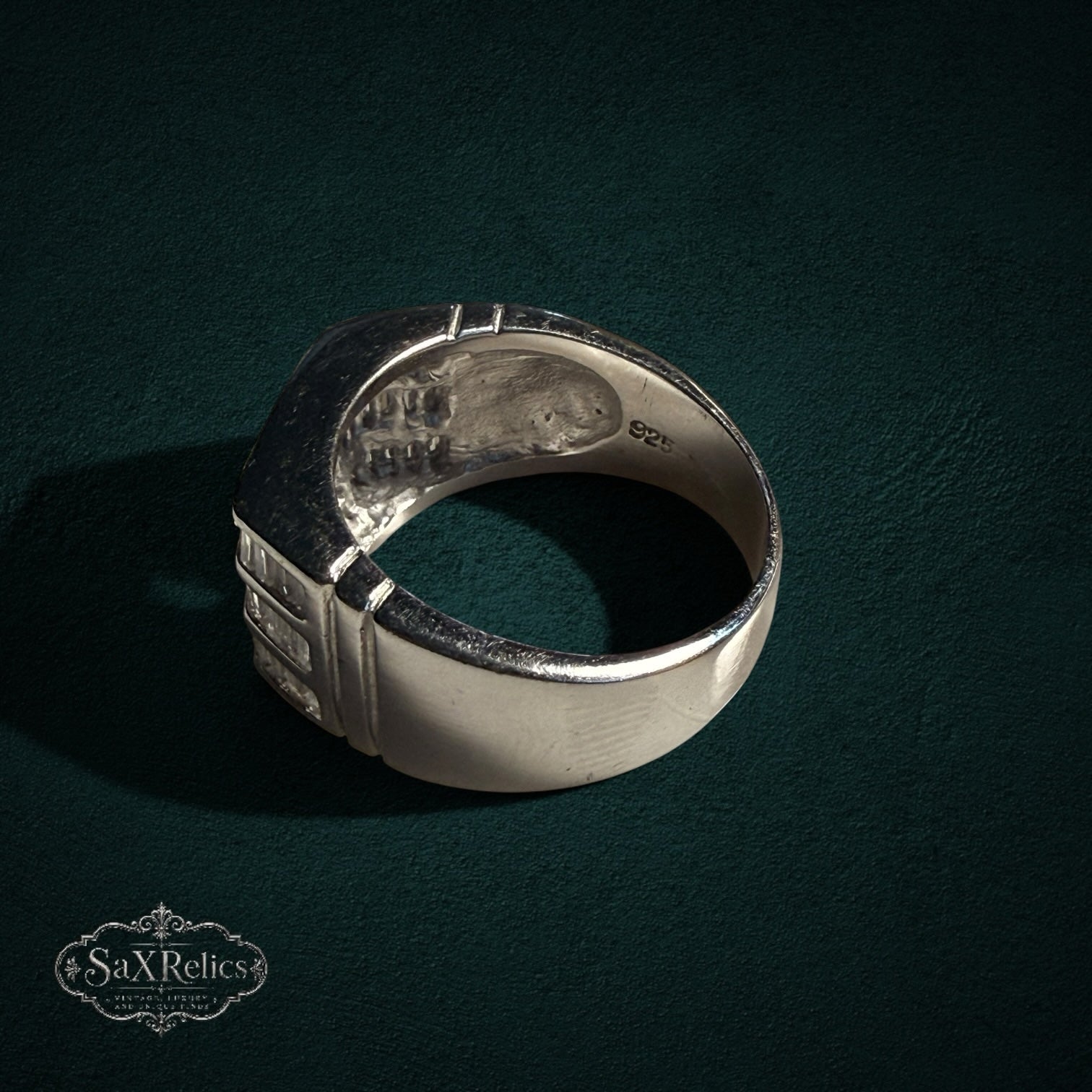 My Store SAXRelics sterling silver statement ring with baguette-cut stones and 925 hallmark on a dark green background