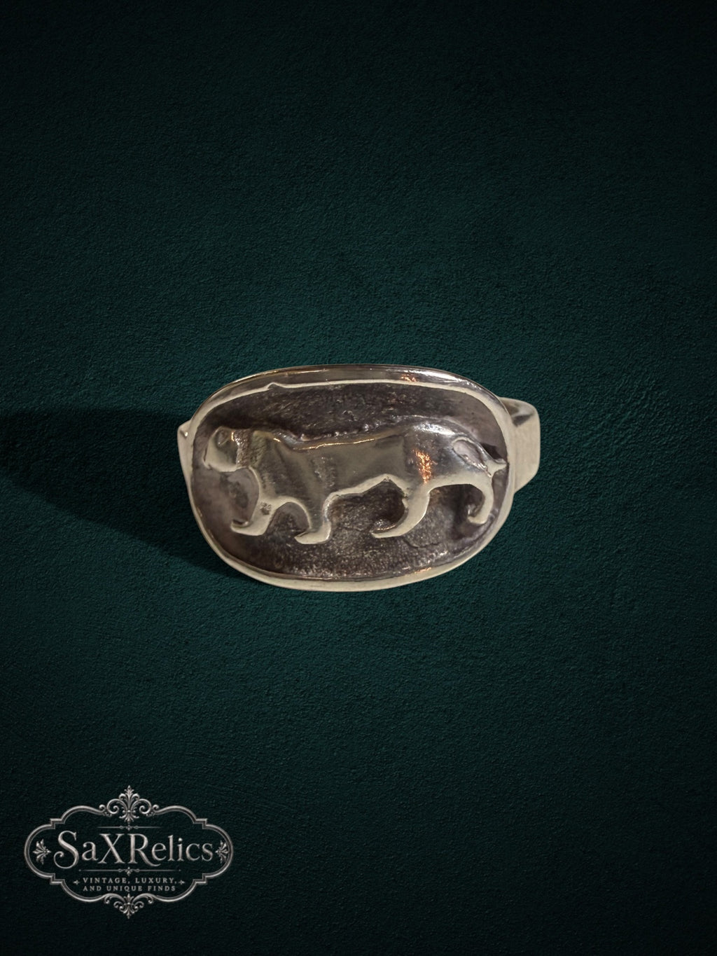 SaX Relics sterling silver signet ring featuring a detailed prowling big cat relief in an oval design.