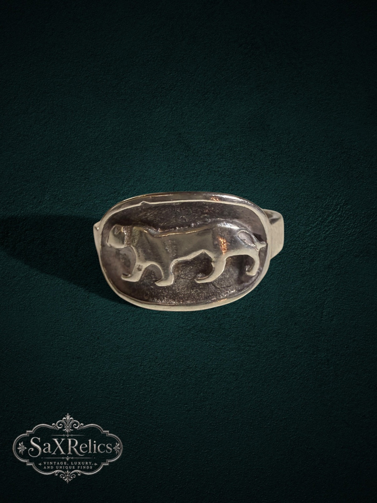 SaX Relics sterling silver signet ring featuring a detailed prowling big cat relief in an oval design.