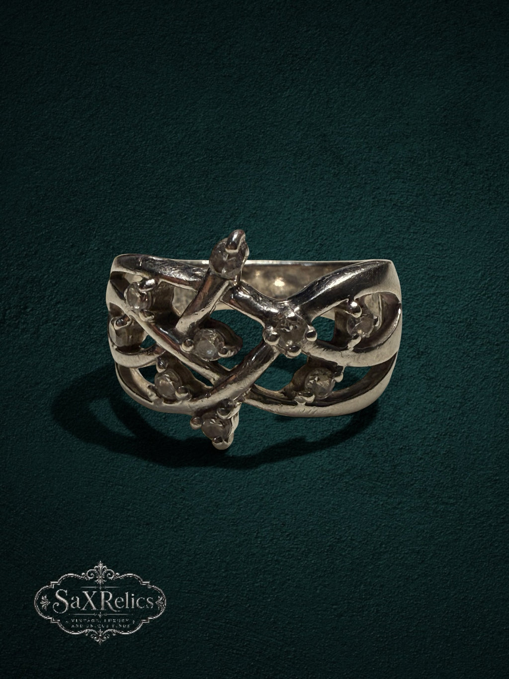 My Store SAXRelics sterling silver statement ring with intricate vine-inspired filigree and clear stone accents.