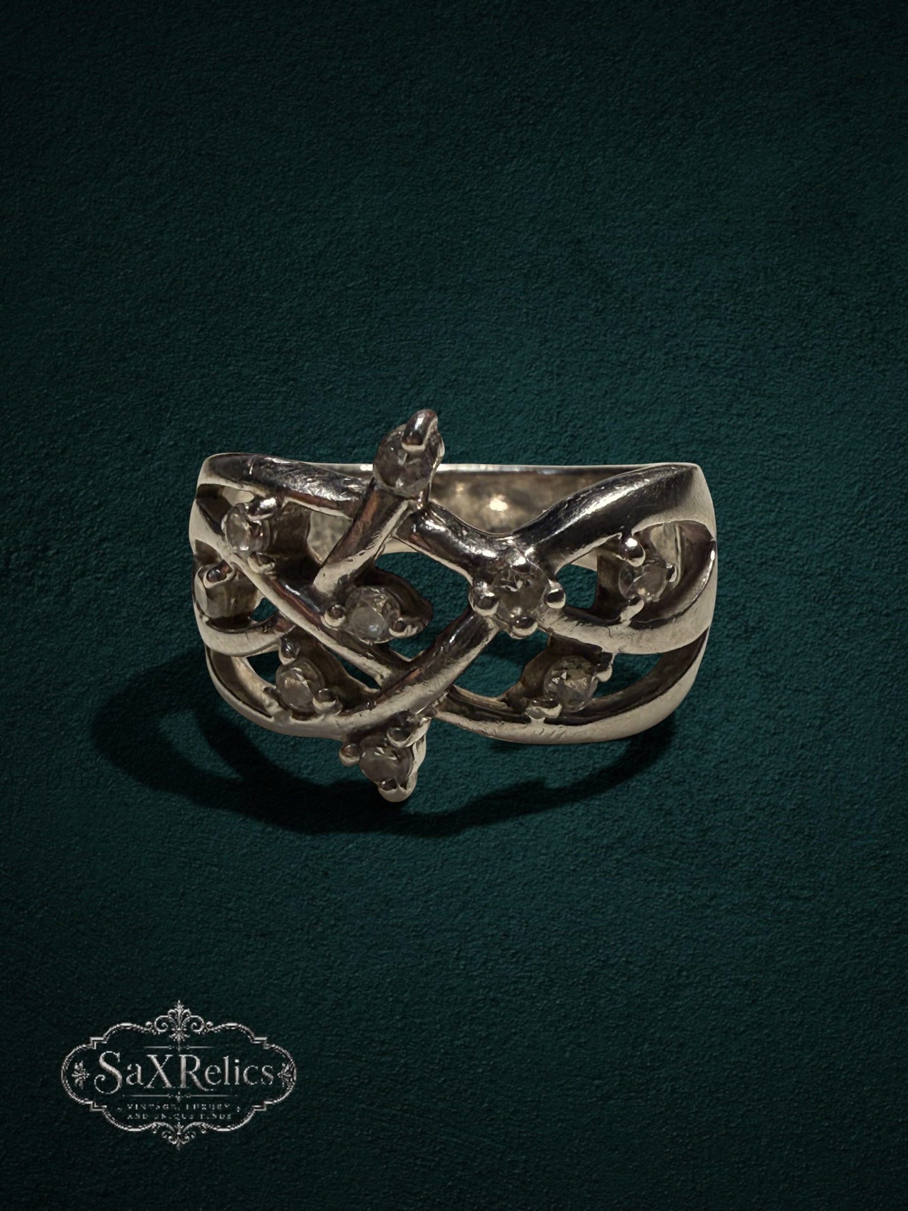 My Store SAXRelics sterling silver statement ring with intricate vine-inspired filigree and clear stone accents.