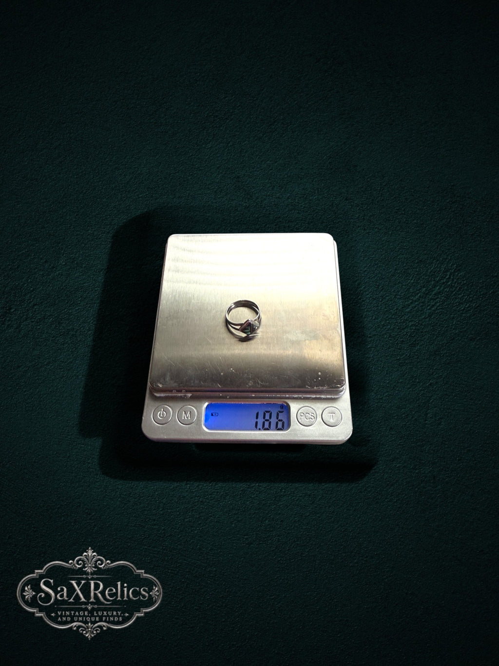 My Store SAXRelics sterling silver geometric ring with mother-of-pearl inlay being weighed on a digital scale