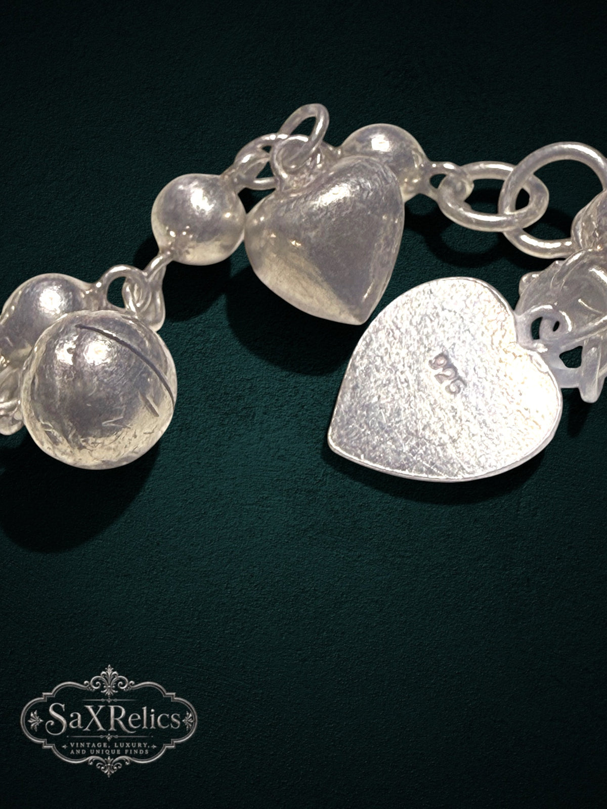 My Store SAXRelics sterling silver heart charm bracelet with polished spheres and 925 hallmark on dark background