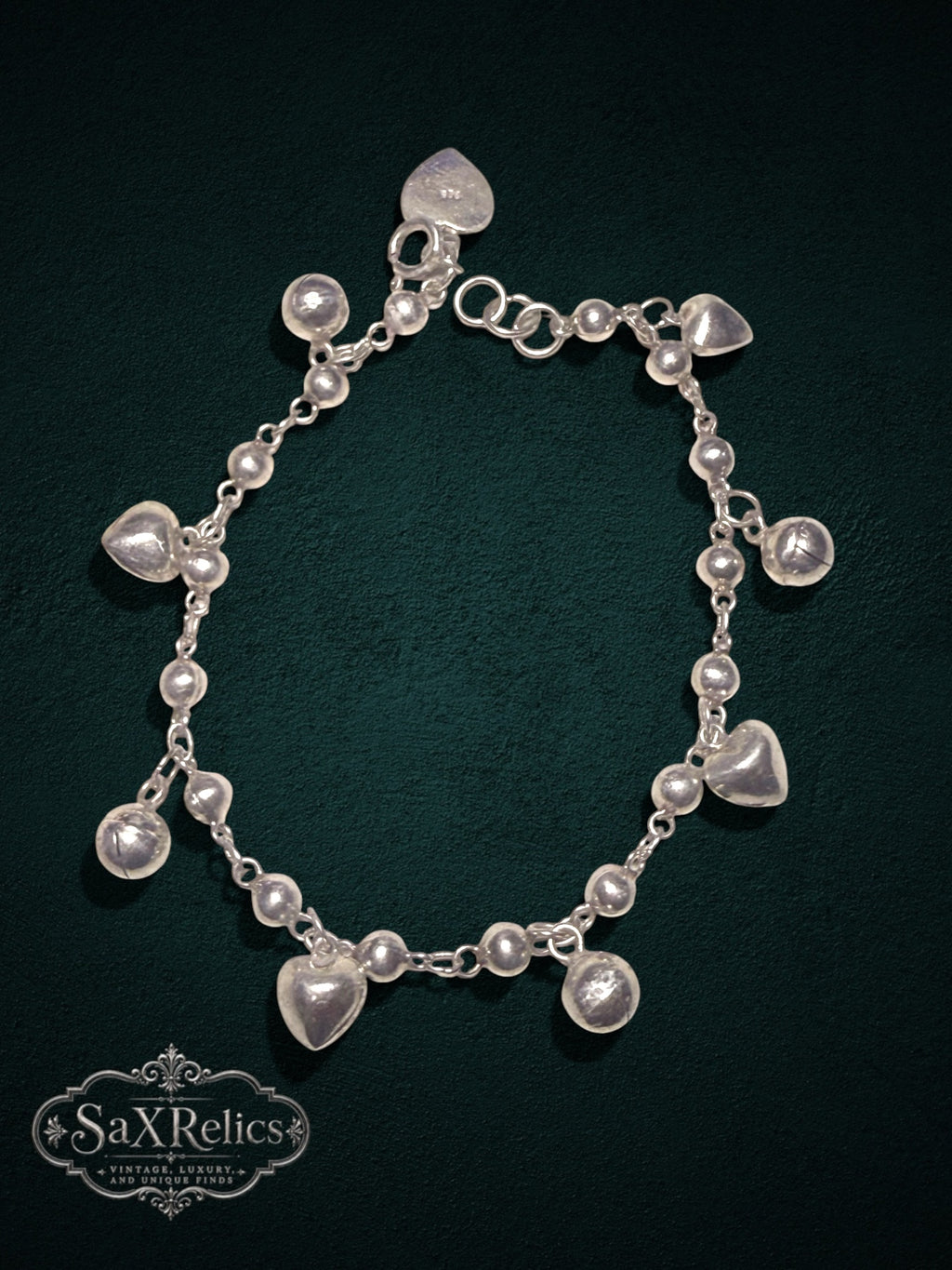 My Store SAXRelics sterling silver charm bracelet featuring polished spheres and heart dangles on a delicate chain