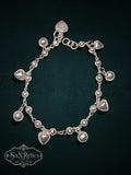 My Store SAXRelics sterling silver charm bracelet featuring polished spheres and heart dangles on a delicate chain
