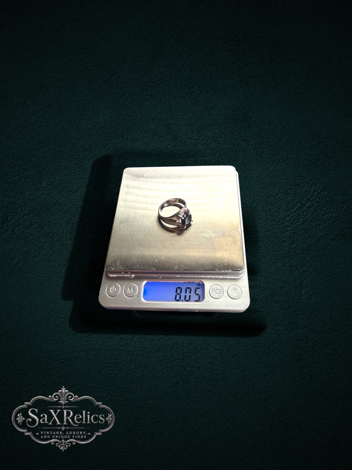 My Store SAXRelics sterling silver ring with dark oval gemstone on a digital scale showing 8.05 grams weight