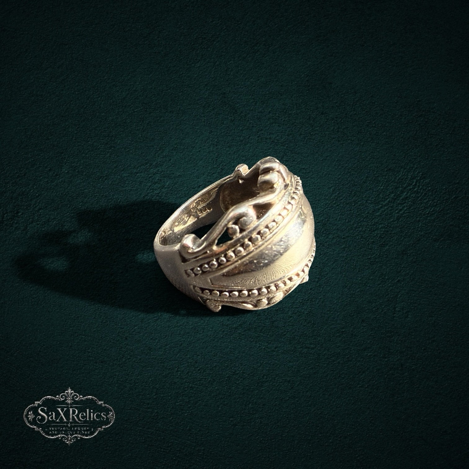 My Store SAXRelics sterling silver statement ring with polished dome, beaded borders, and intricate scrollwork detail.