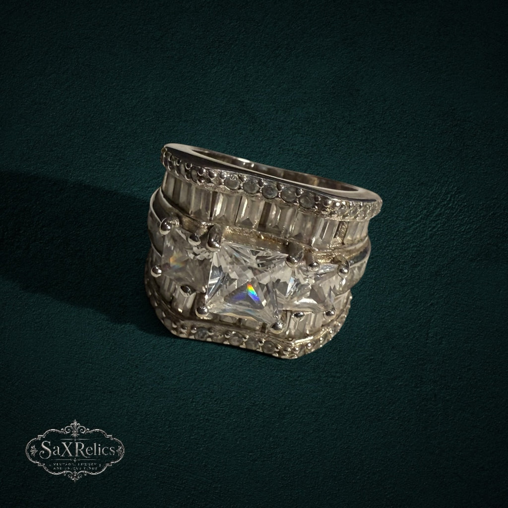 My Store SAXRelics wide sterling silver statement ring with baguette and princess-cut stones on a dark background