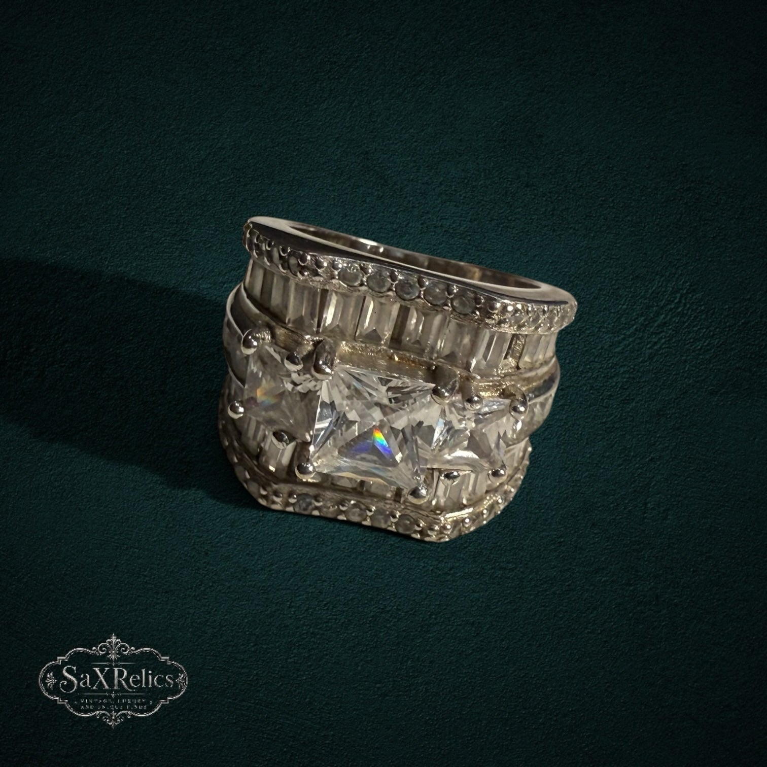 My Store SAXRelics wide sterling silver statement ring with baguette and princess-cut stones on a dark background