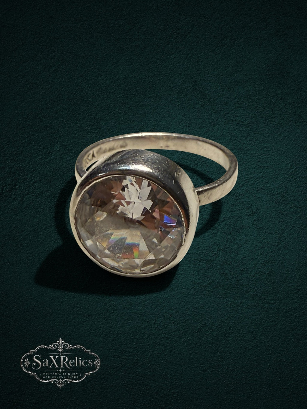 My Store SAXRelics sterling silver statement ring featuring a large faceted clear stone in a minimalist bezel setting.