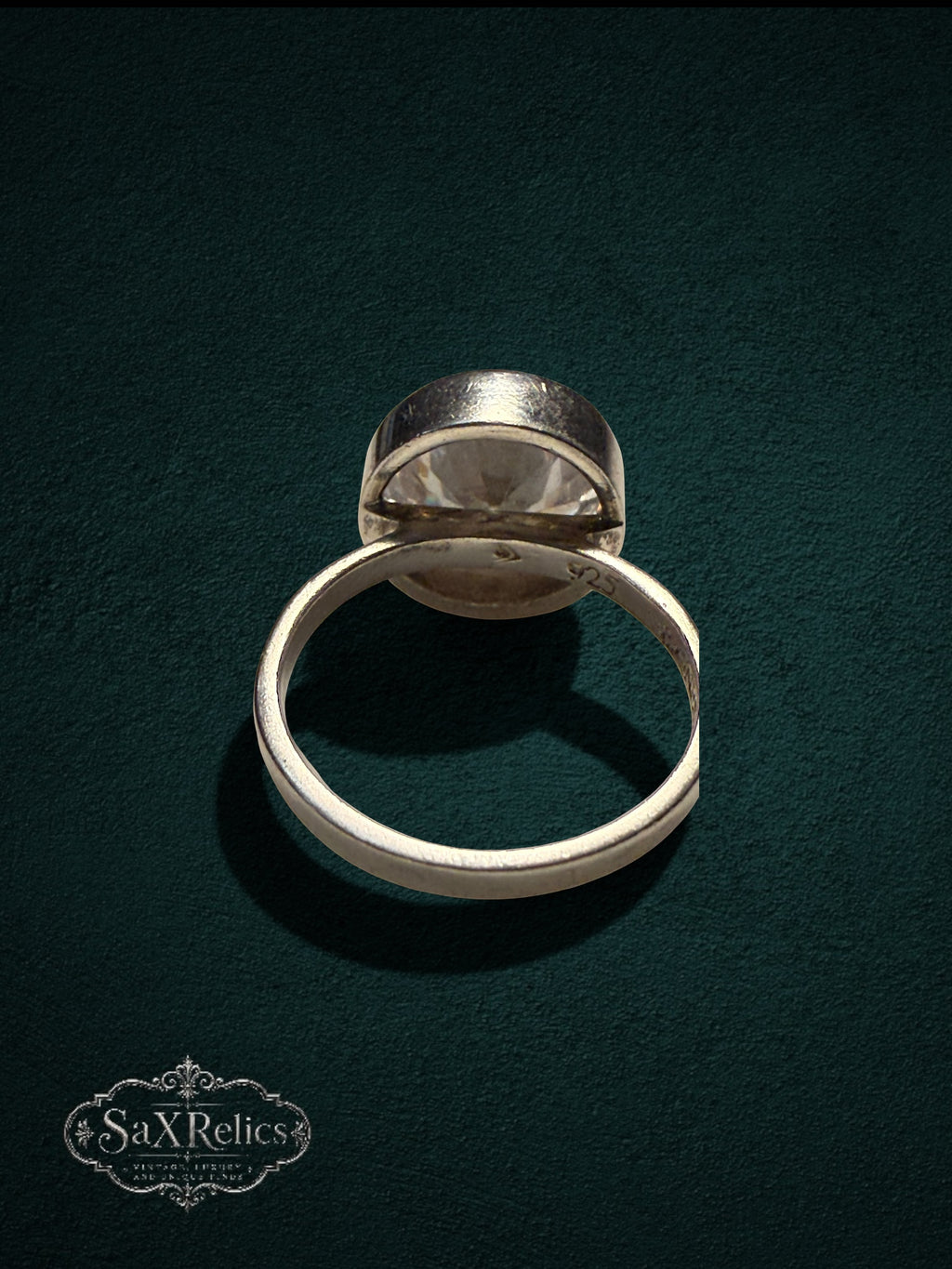 My Store SAXRelics sterling silver statement ring with a large clear faceted stone in a minimalist bezel setting.