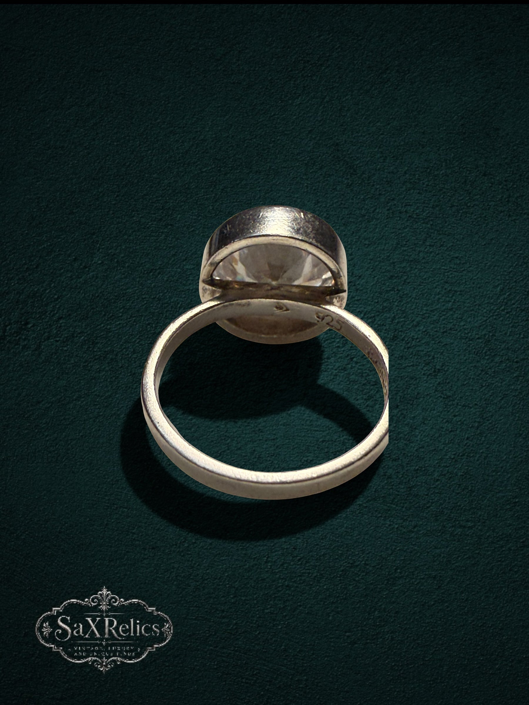 My Store SAXRelics sterling silver statement ring with a large clear faceted stone in a minimalist bezel setting.