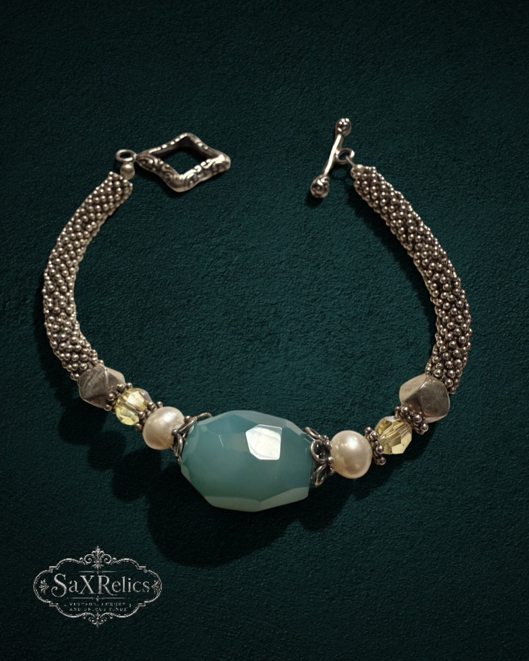 My Store SaxRelics beaded statement bracelet with a faceted teal gemstone, pearls, yellow crystals, and silver mesh chain