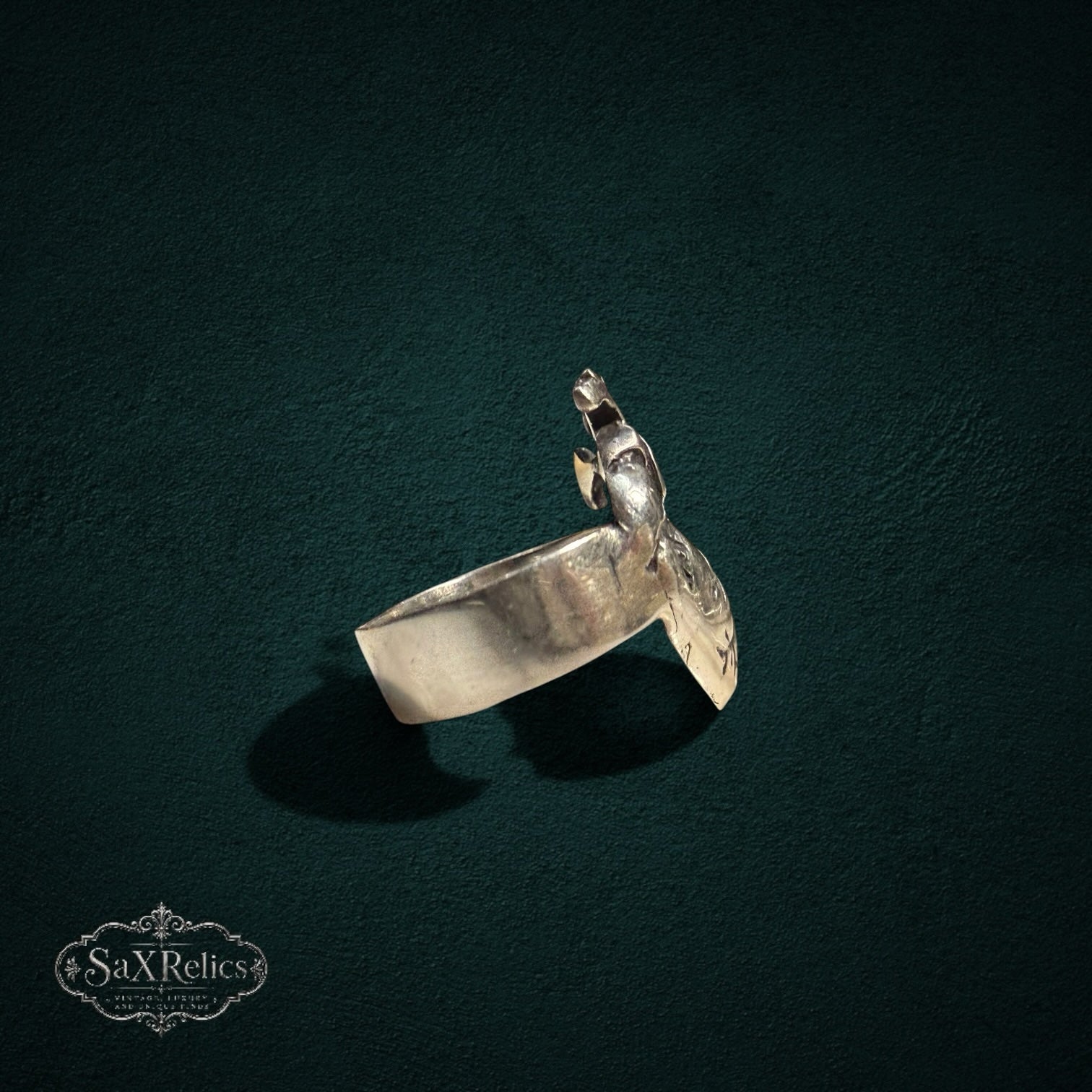 My Store SAXRelics silver anatomical heart statement ring with detailed realistic design on a dark textured background