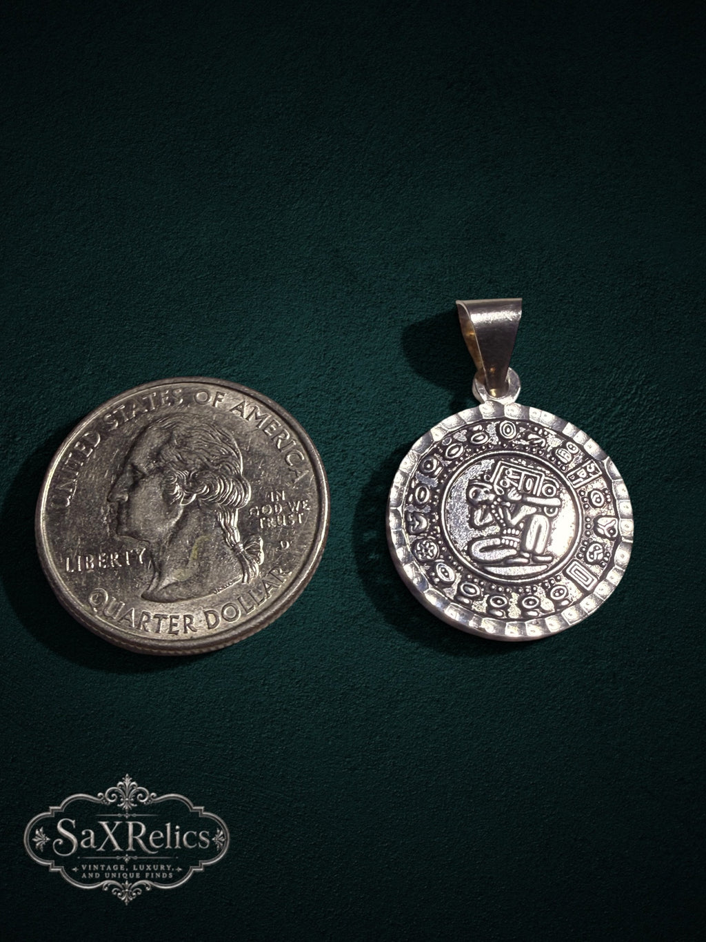 Tonalli sterling silver Aztec calendar pendant next to a US quarter for size