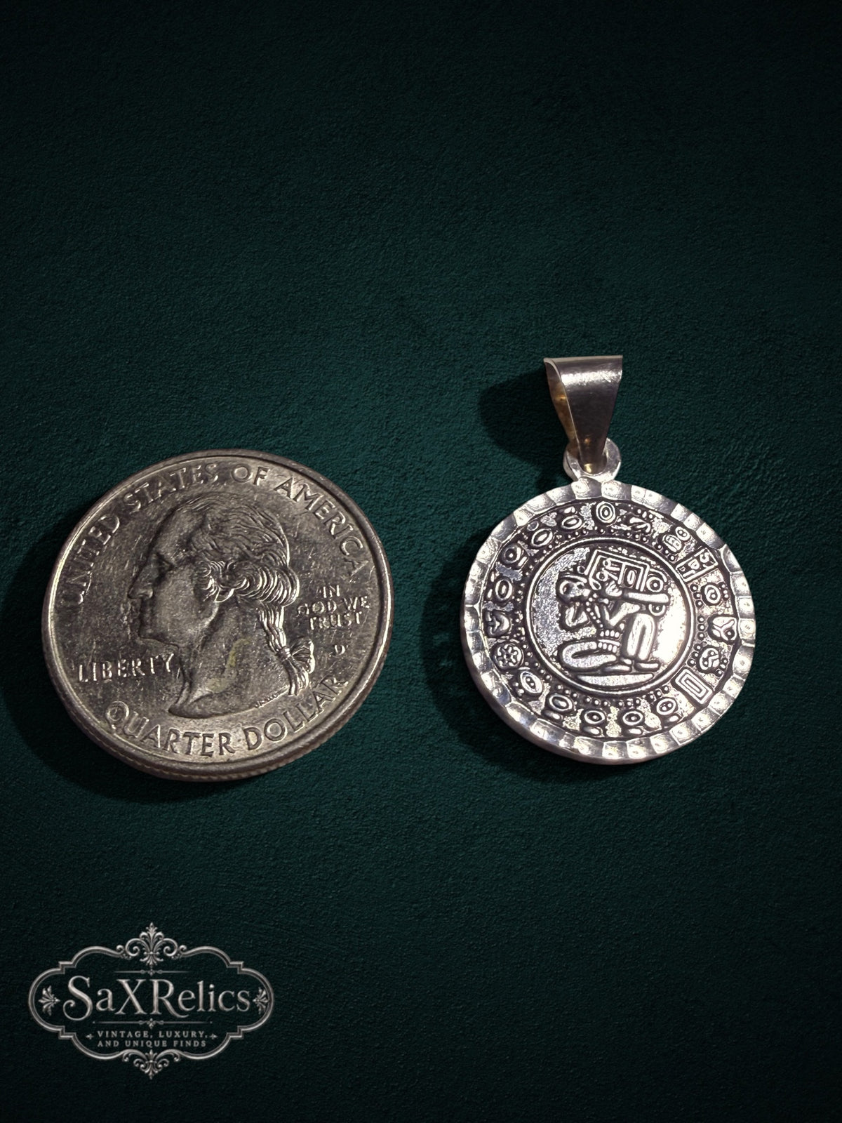 Tonalli sterling silver Aztec calendar pendant next to a US quarter for size