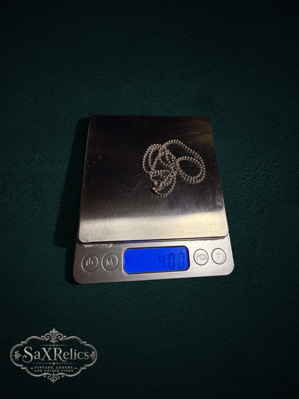 Perlita sterling silver ball chain weighing 4 grams on a scale