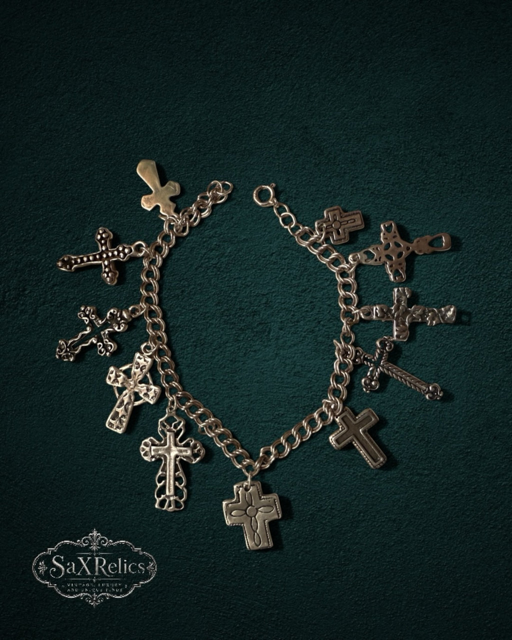 My Store SaxRelics silver-tone charm bracelet featuring various ornate and minimalist cross pendants on a chain