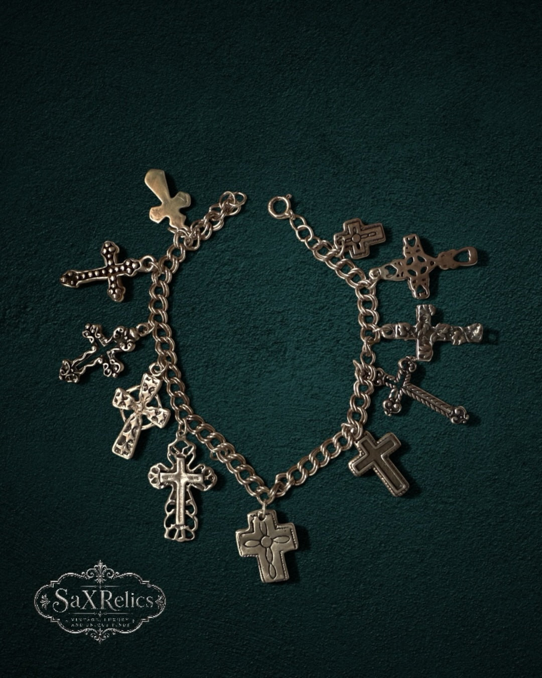 My Store SaxRelics silver-tone charm bracelet featuring various ornate and minimalist cross pendants on a chain