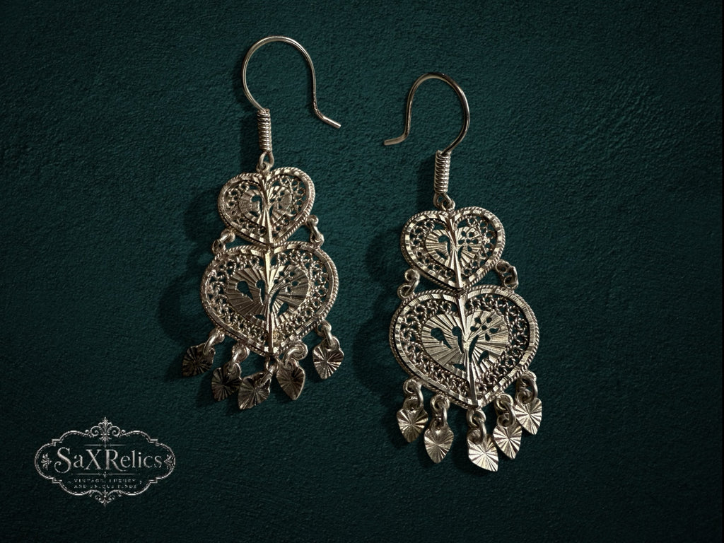 My Store SAXRelics silver filigree double-heart drop earrings with intricate metalwork and dangling charms.