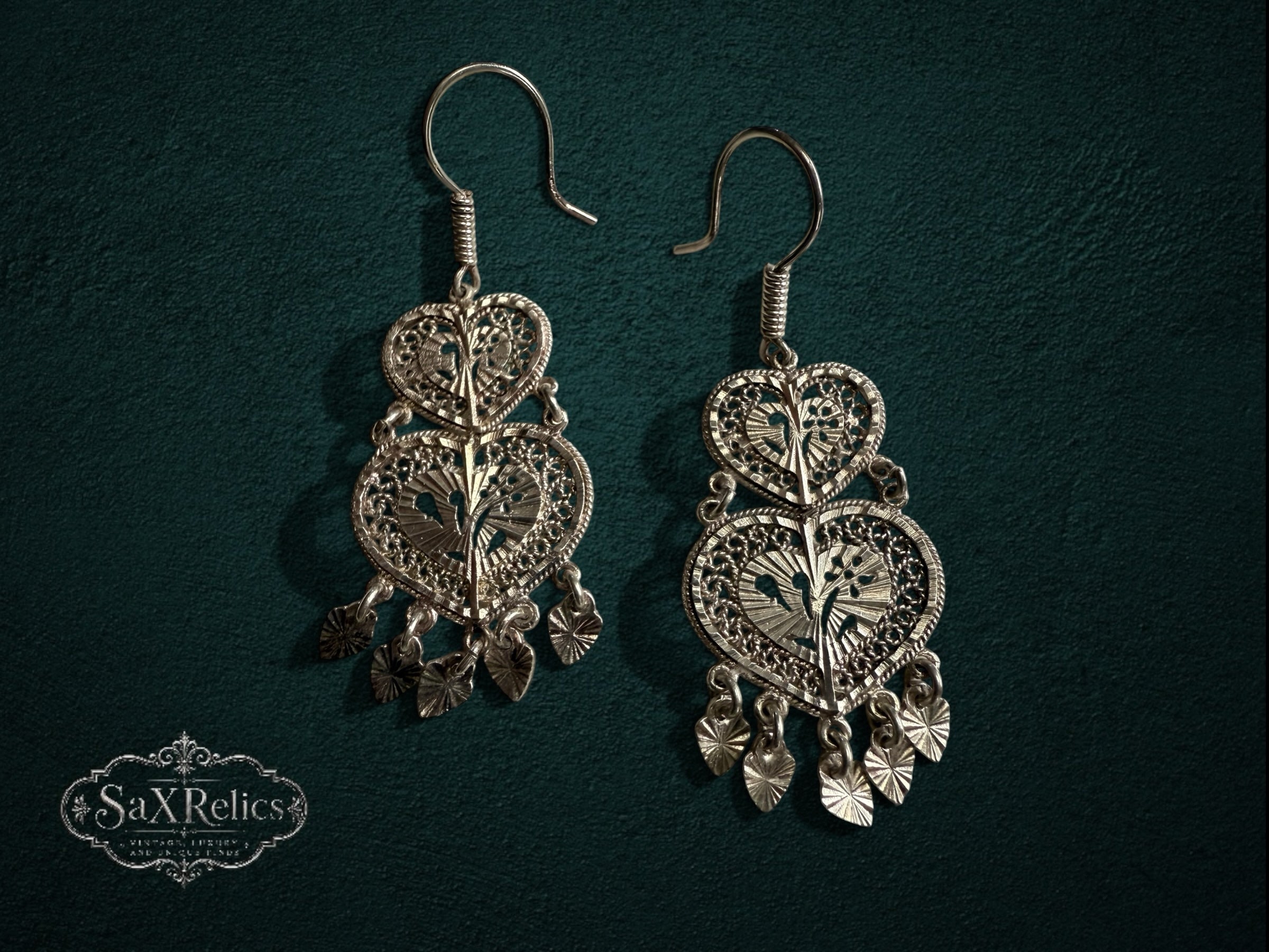 My Store SAXRelics silver filigree double-heart drop earrings with intricate metalwork and dangling charms.
