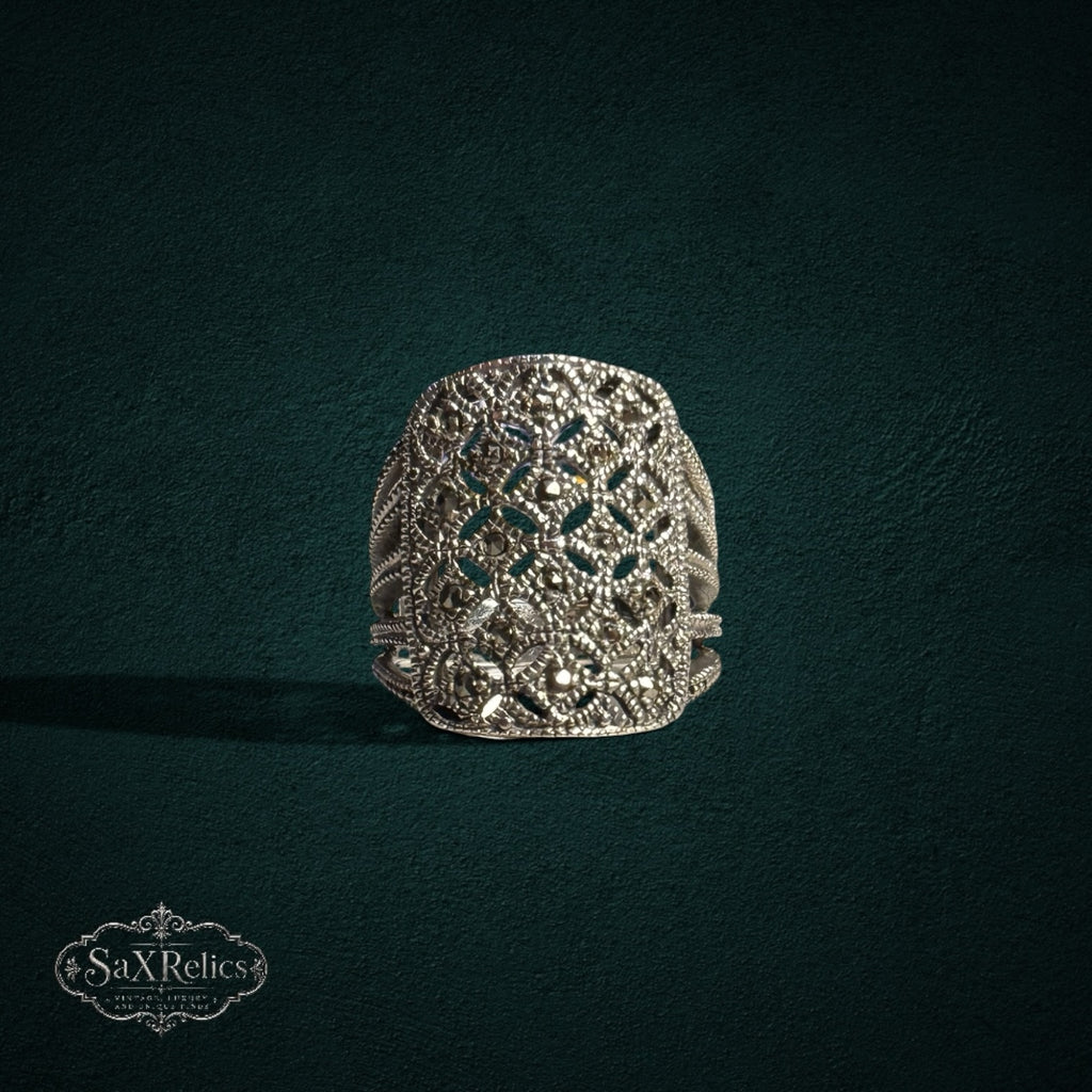 My Store SAXRelics silver statement ring with intricate filigree openwork and shimmering marcasite stone accents.