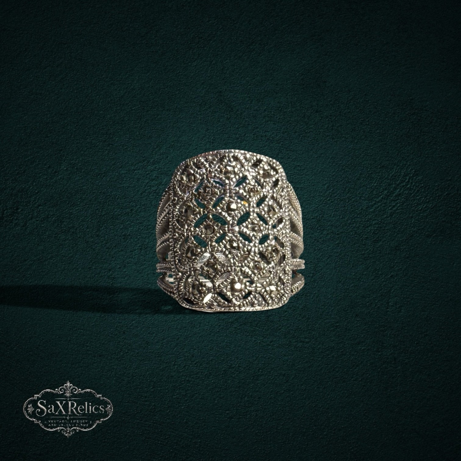 My Store SAXRelics silver statement ring with intricate filigree openwork and shimmering marcasite stone accents.