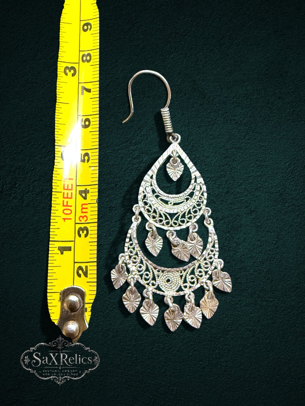 My Store SaxRelics silver-tone filigree teardrop chandelier earrings with dangling leaf charms on a dark background