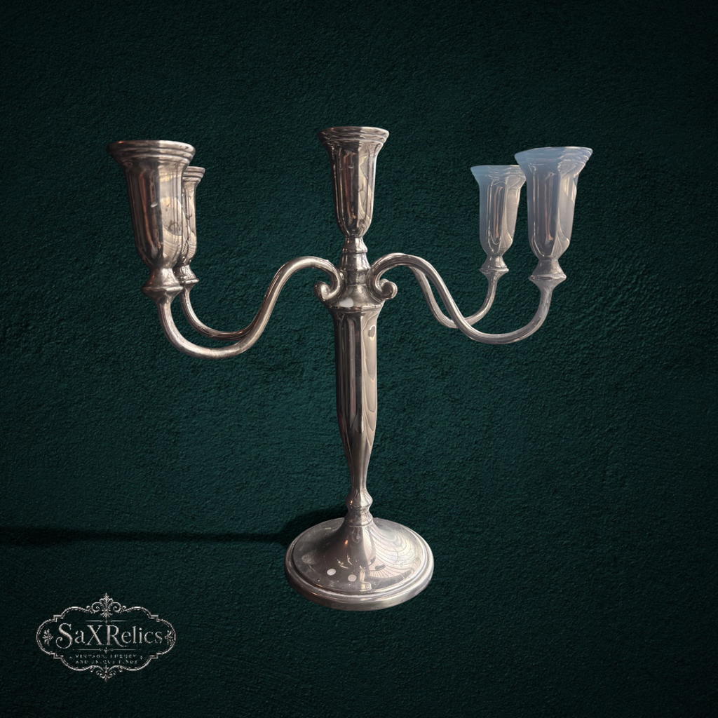 My Store silver-plated five-arm candelabra with a polished finish and traditional sweeping design on a table.
