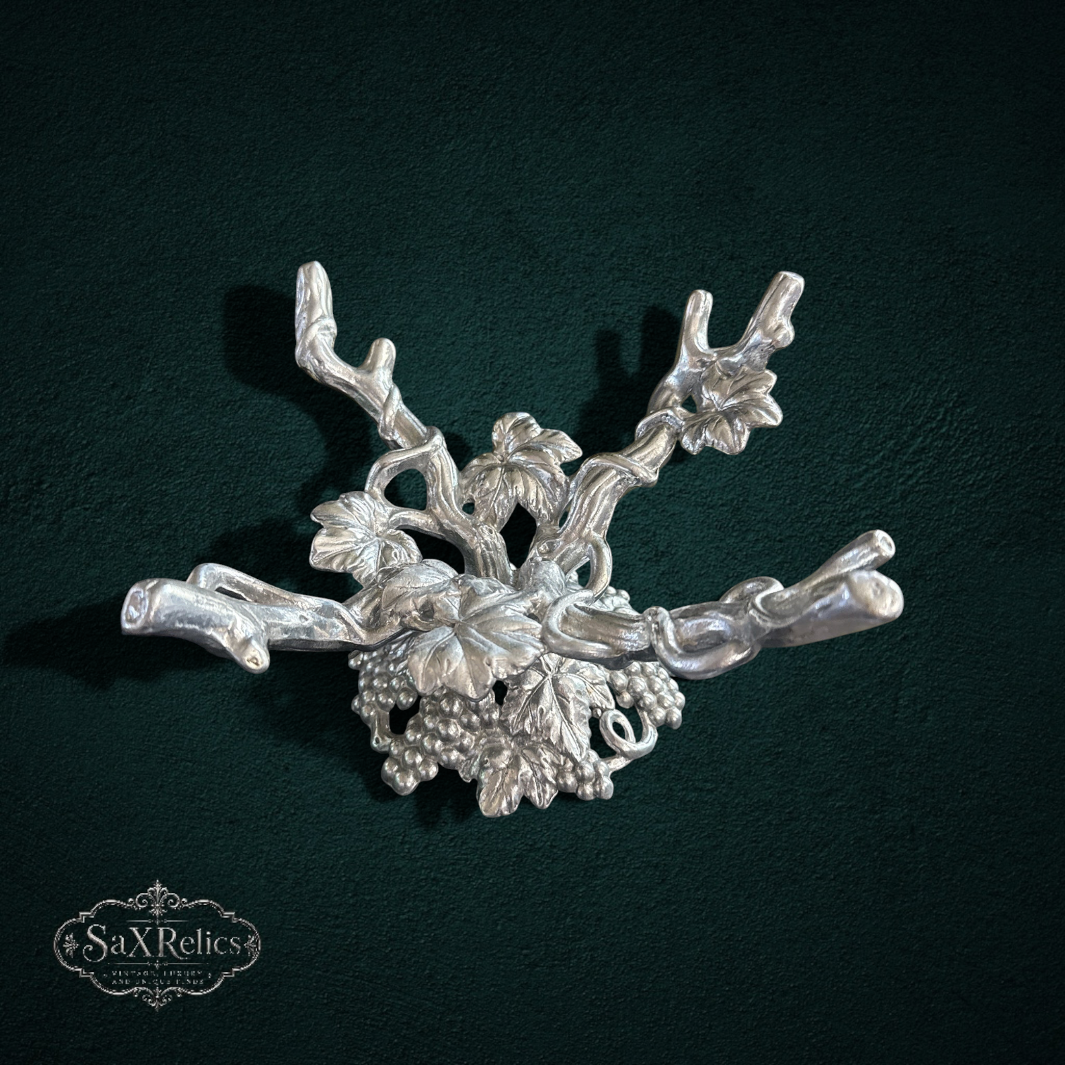 My Store silver metal tabletop stand with intricate grapevine and leaf motif for displaying fruit or decor.