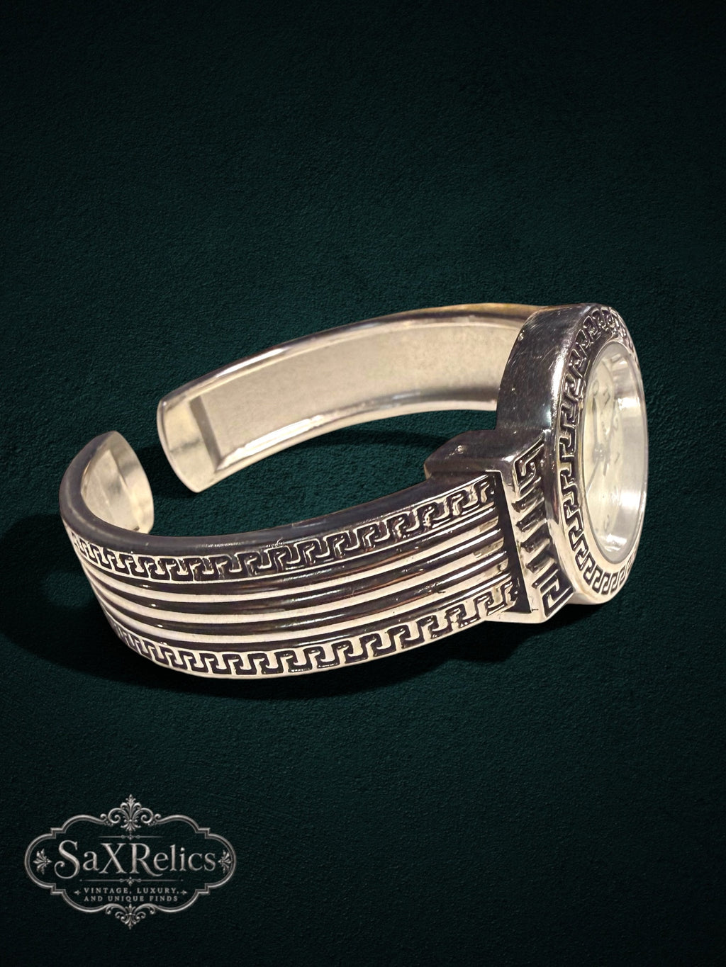 My Store silver-tone cuff watch featuring an intricate Greek key motif and a mother-of-pearl dial.