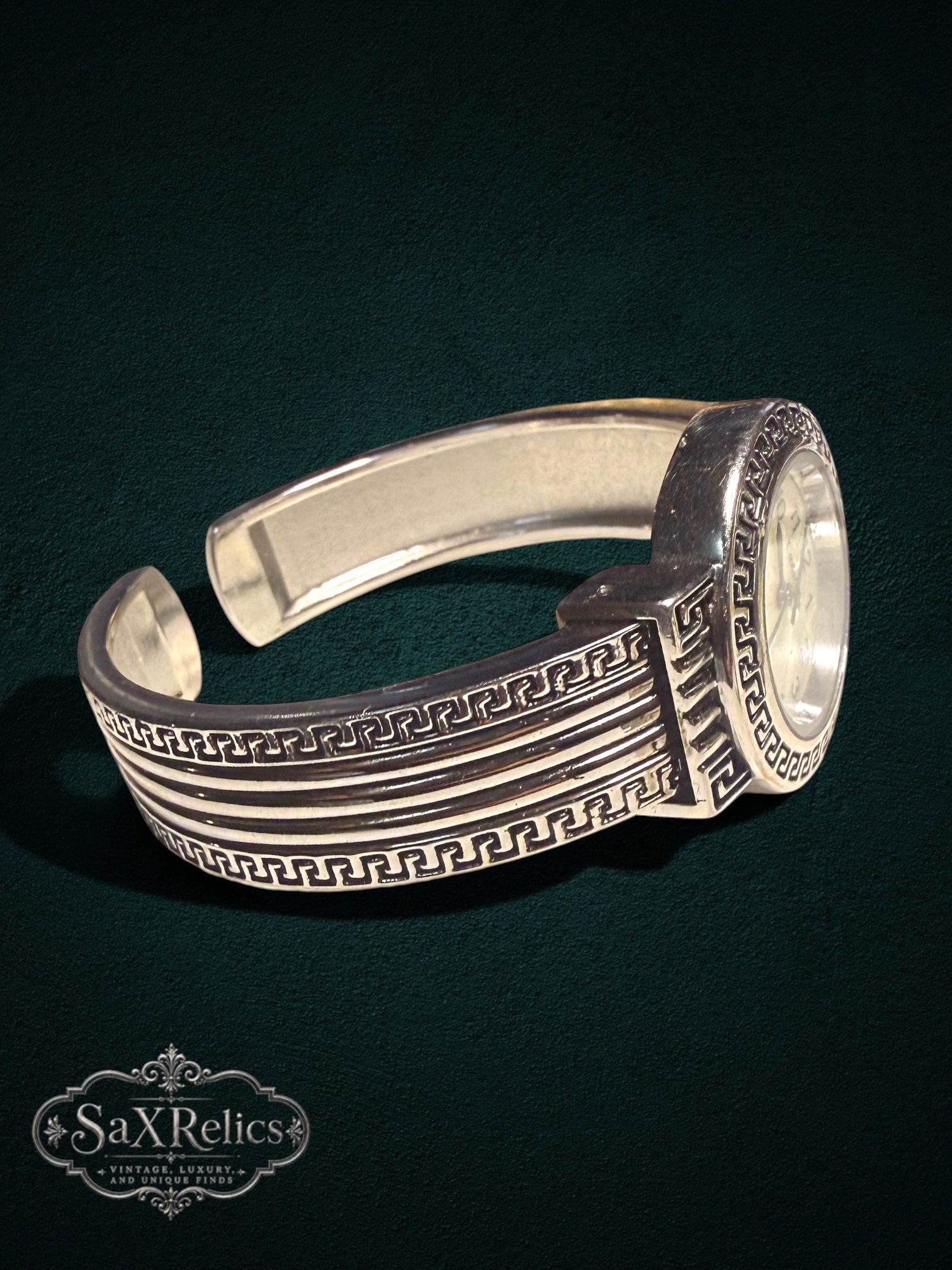 My Store silver-tone cuff watch featuring an intricate Greek key motif and a mother-of-pearl dial.