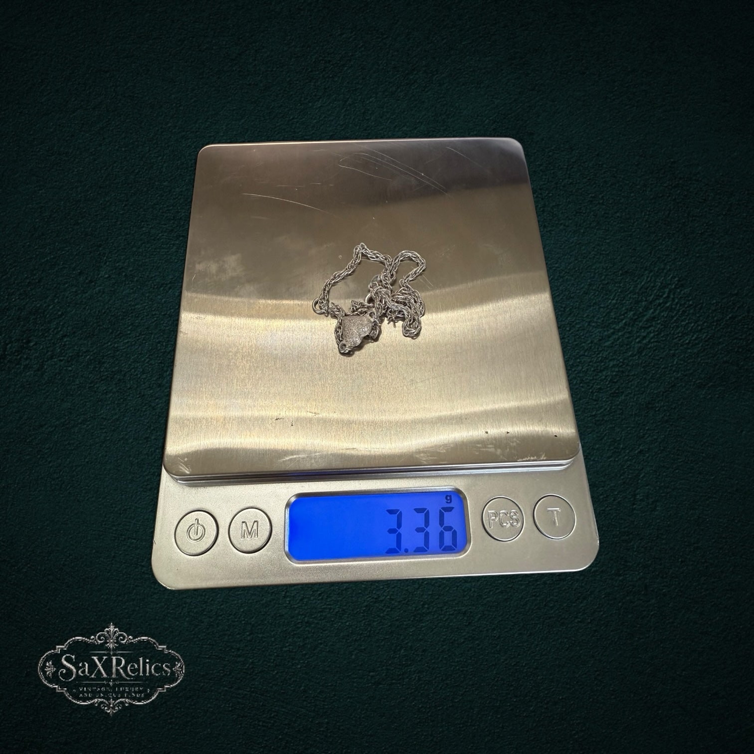 SaX Relics sterling silver heart charm anklet on a digital scale