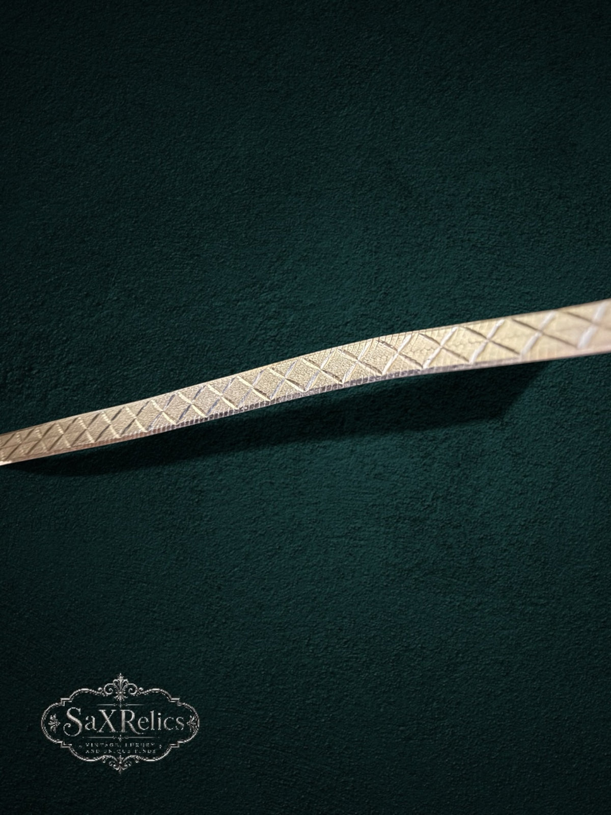 My Store silver-tone herringbone chain necklace with a diamond-cut crosshatch pattern on a dark green background