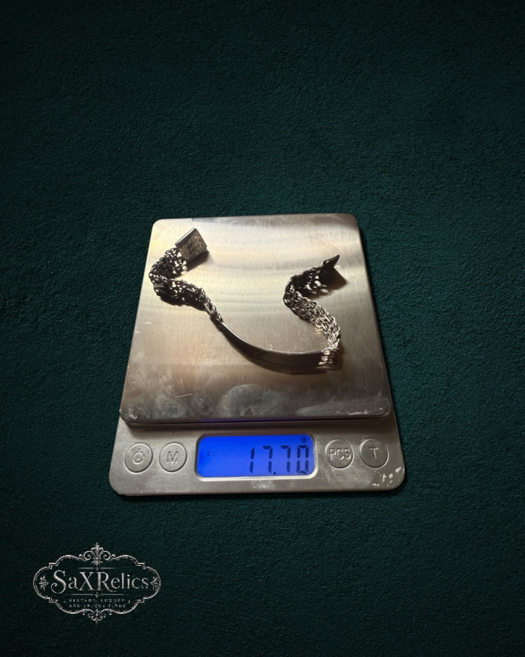 My Store SAXRelics silver link chain bracelet with identification plate on a digital scale weighing 17.70 grams