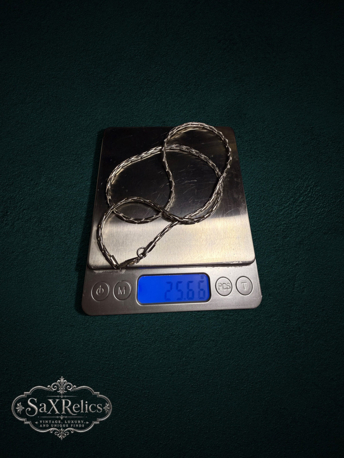 Muralla sterling silver chain weighing 25.66 grams on a scale