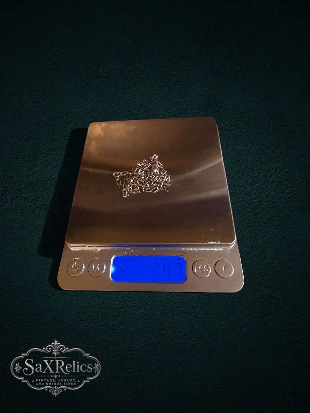 Elipse sterling silver oval link chain weighing 3 grams on a scale