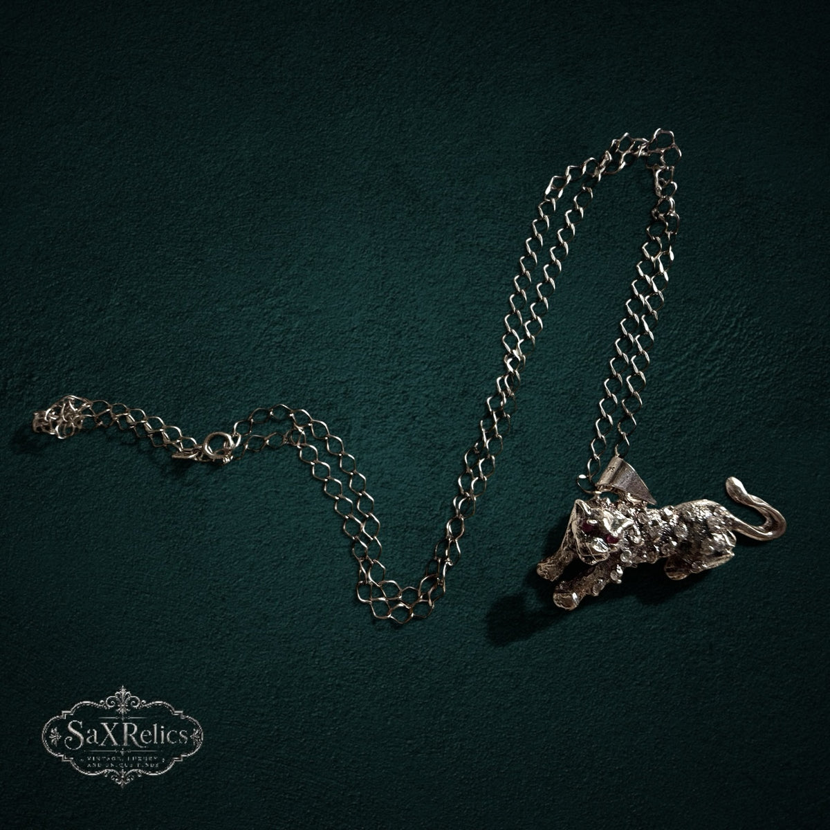 SaX Relics — Pantera sterling silver panther pendant necklace shown full length on a dark backdrop.