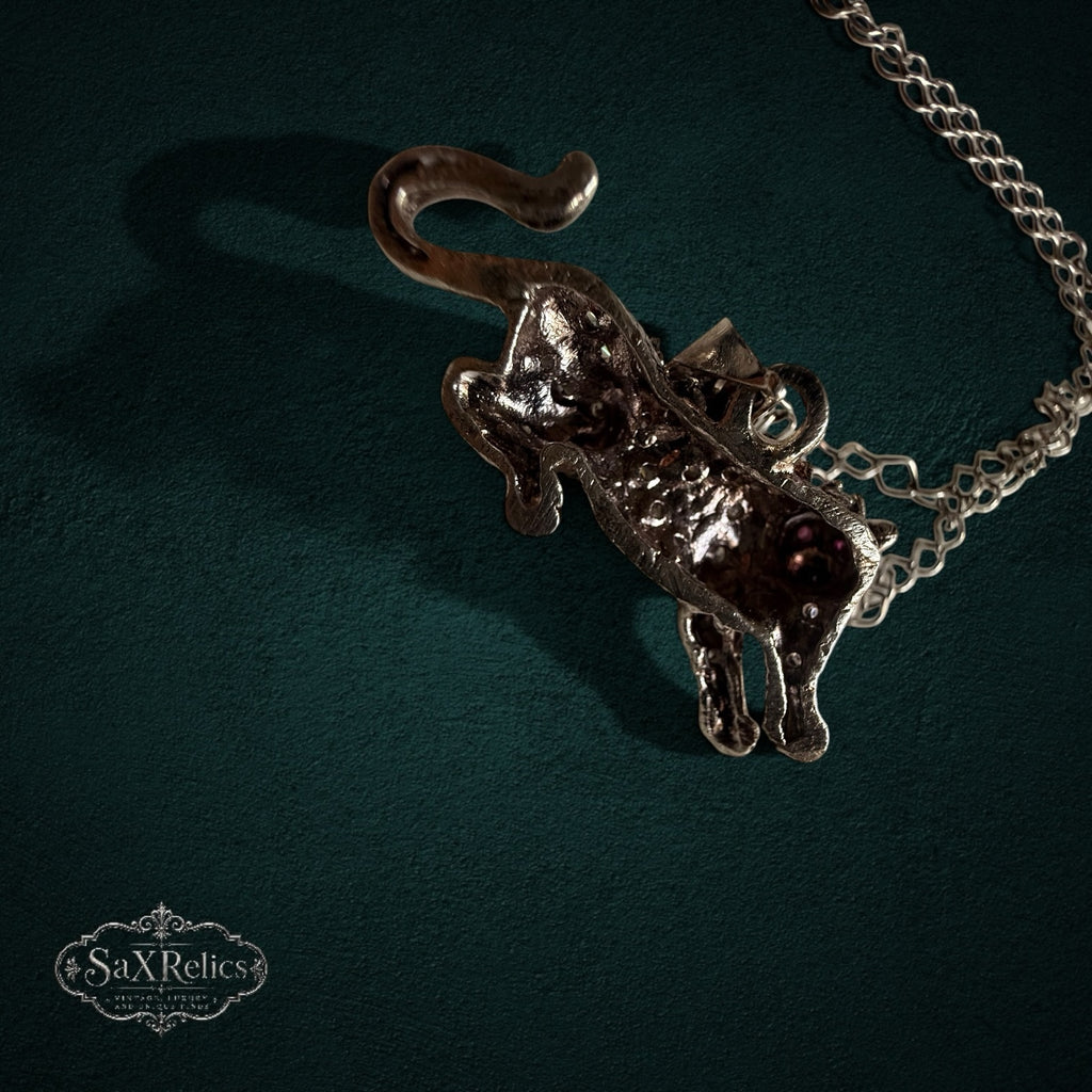 SaX Relics — Pantera sterling silver panther pendant, detail of the sculpted form and red stone eyes.