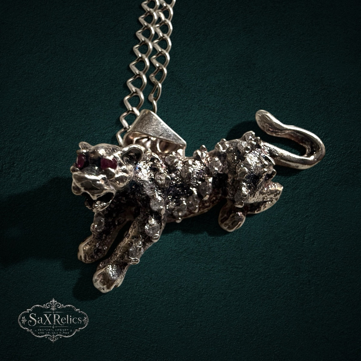 SaX Relics — Pantera Mexican sterling silver leaping panther pendant with red cubic zirconia eyes on a link chain.