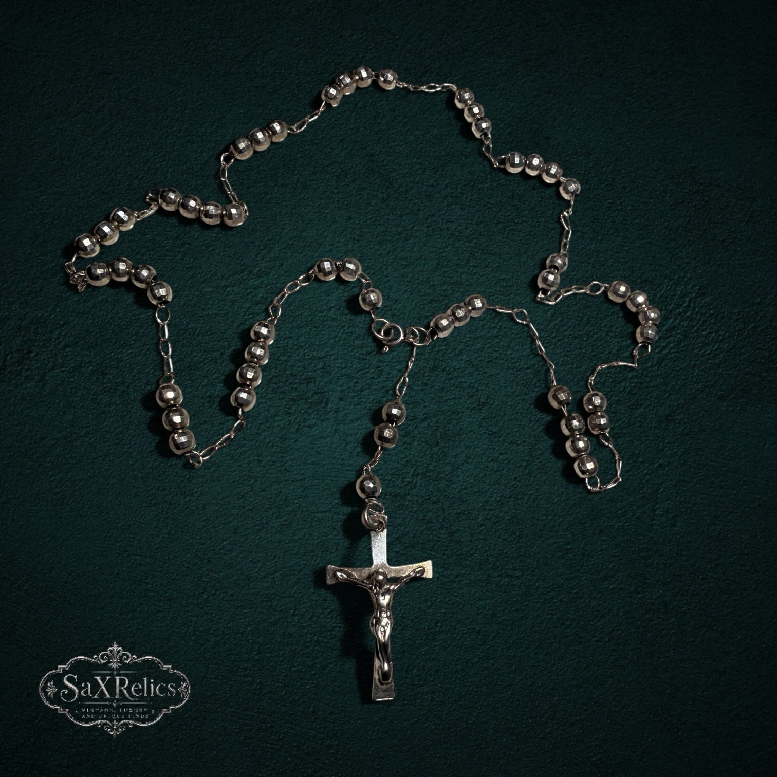 My Store SAXRelics silver-tone metallic prayer rosary beads with a detailed crucifix centerpiece on dark background