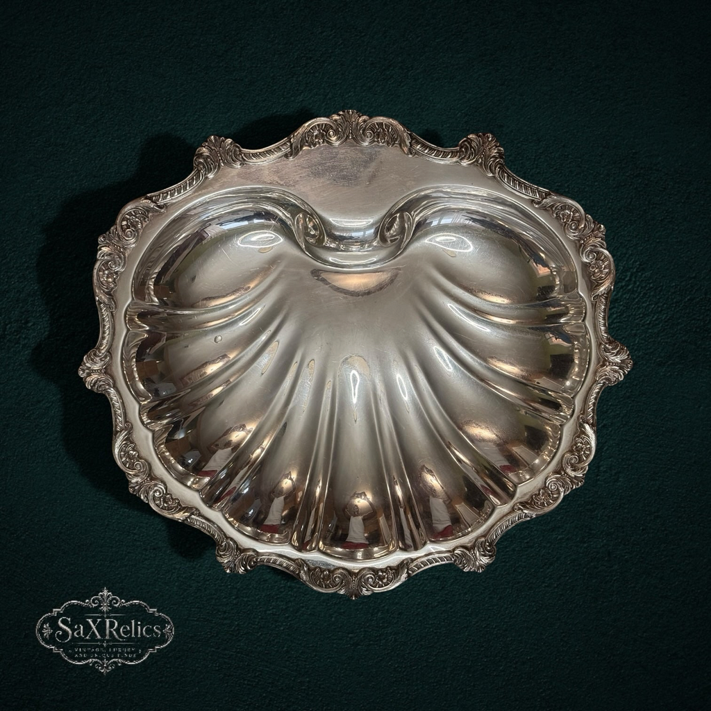 My Store vintage silver-plated scalloped shell serving dish with an ornate decorative border on a dark background.