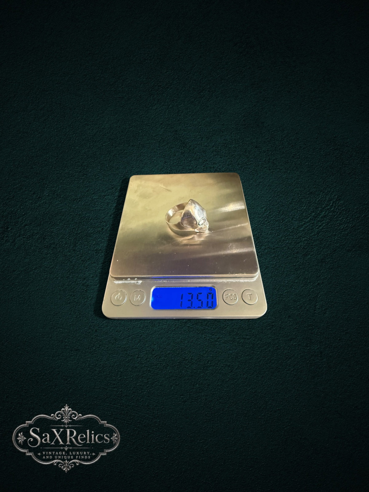 Calavera sterling silver skull ring on a digital scale