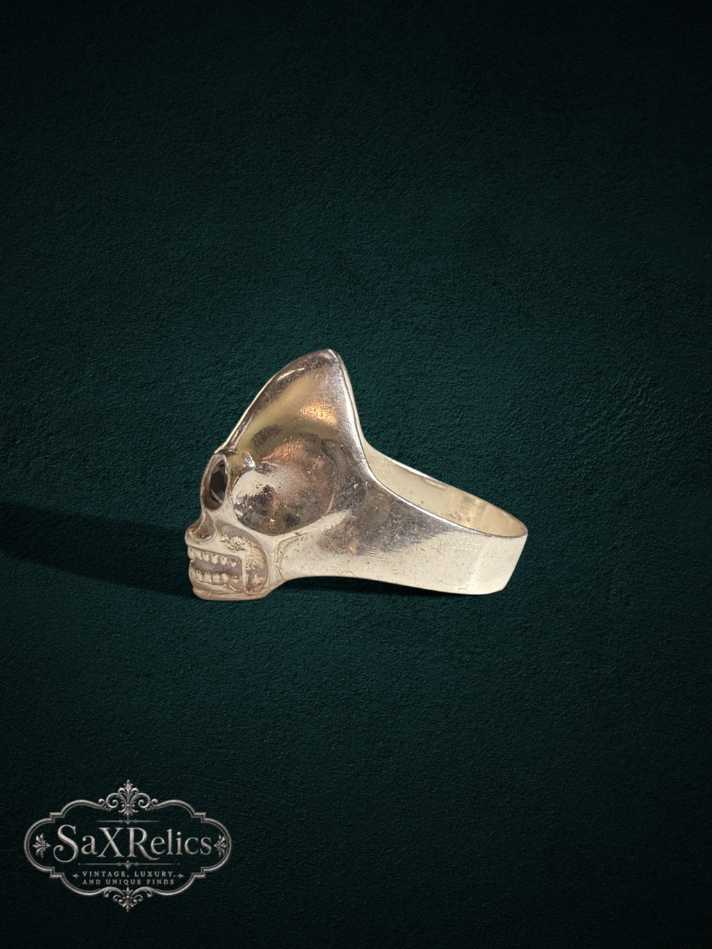 Calavera sterling silver skull statement ring on a dark background