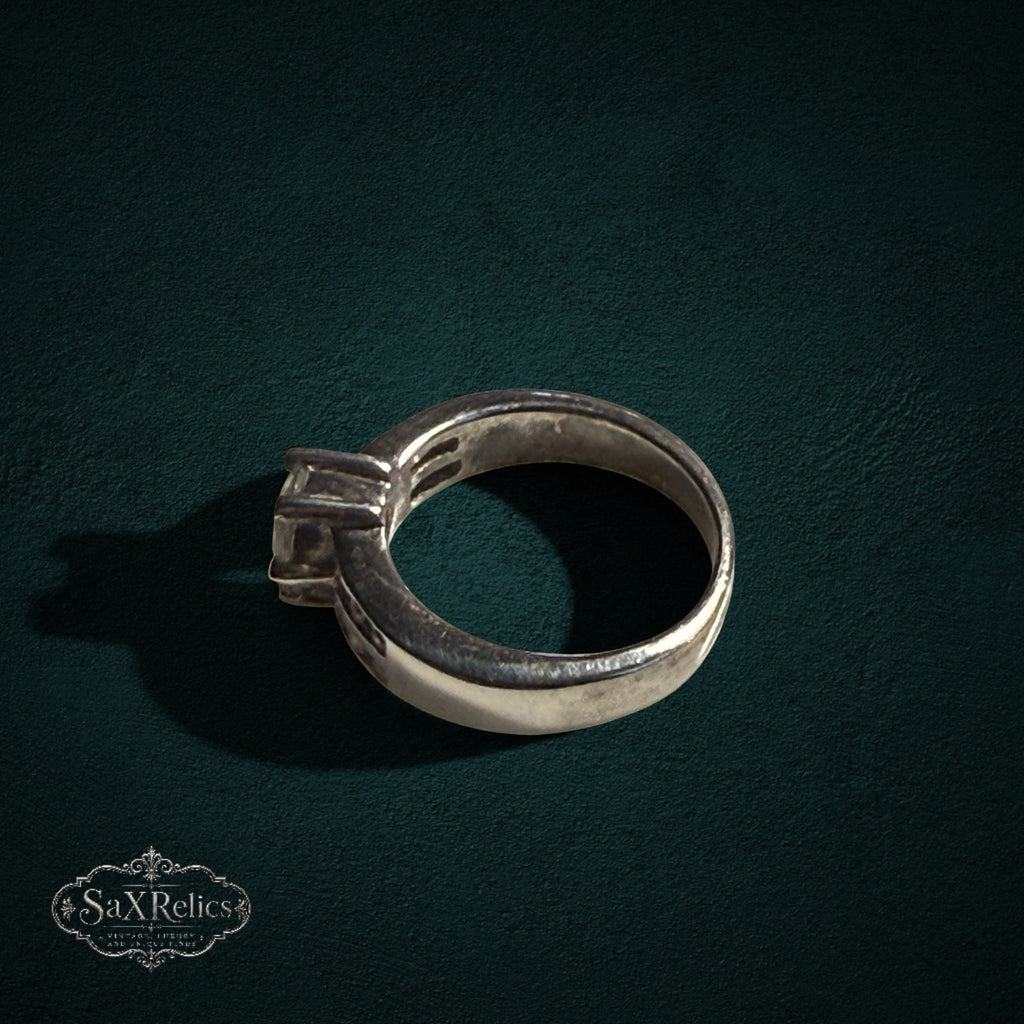 My Store silver-tone solitaire ring with a prong-set center stone on a dark textured background
