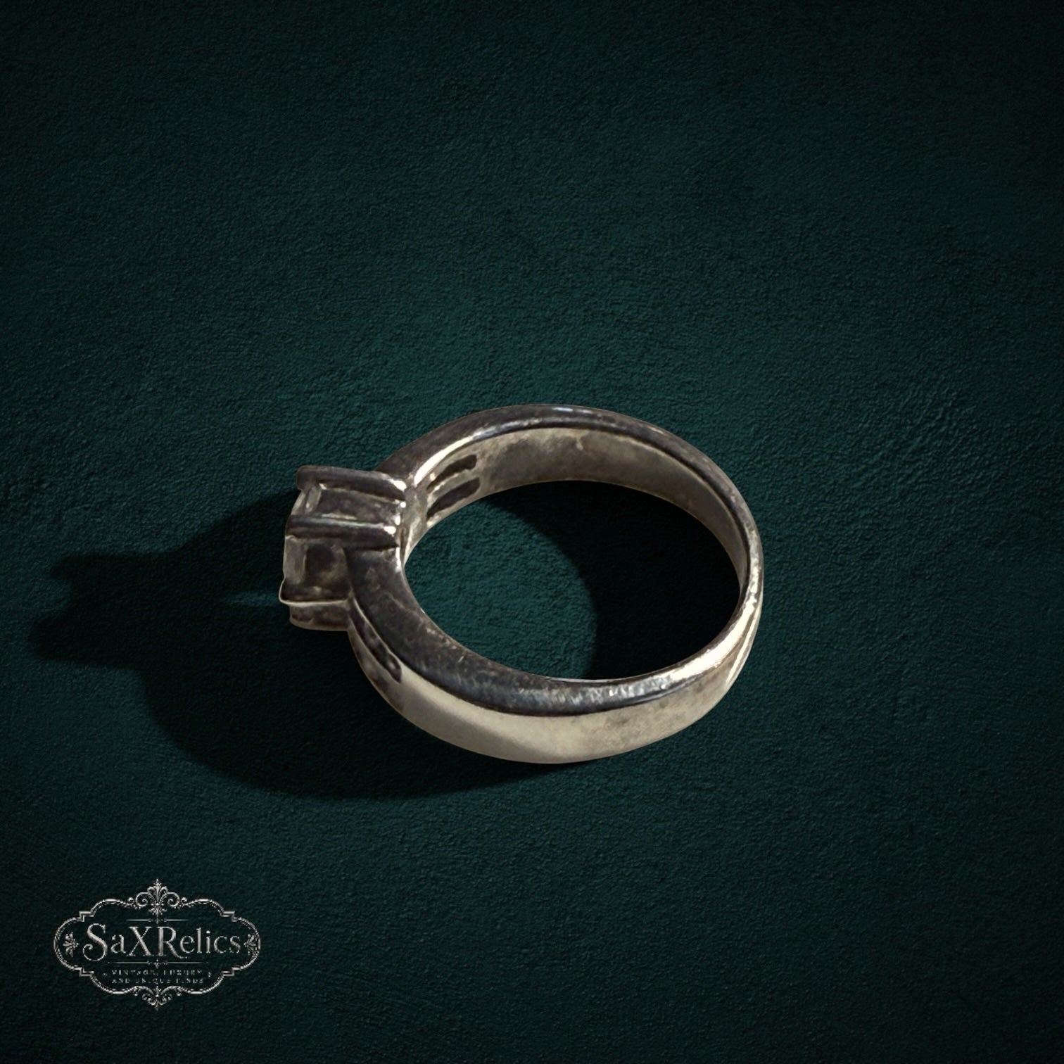 My Store silver-tone solitaire ring with a prong-set center stone on a dark textured background