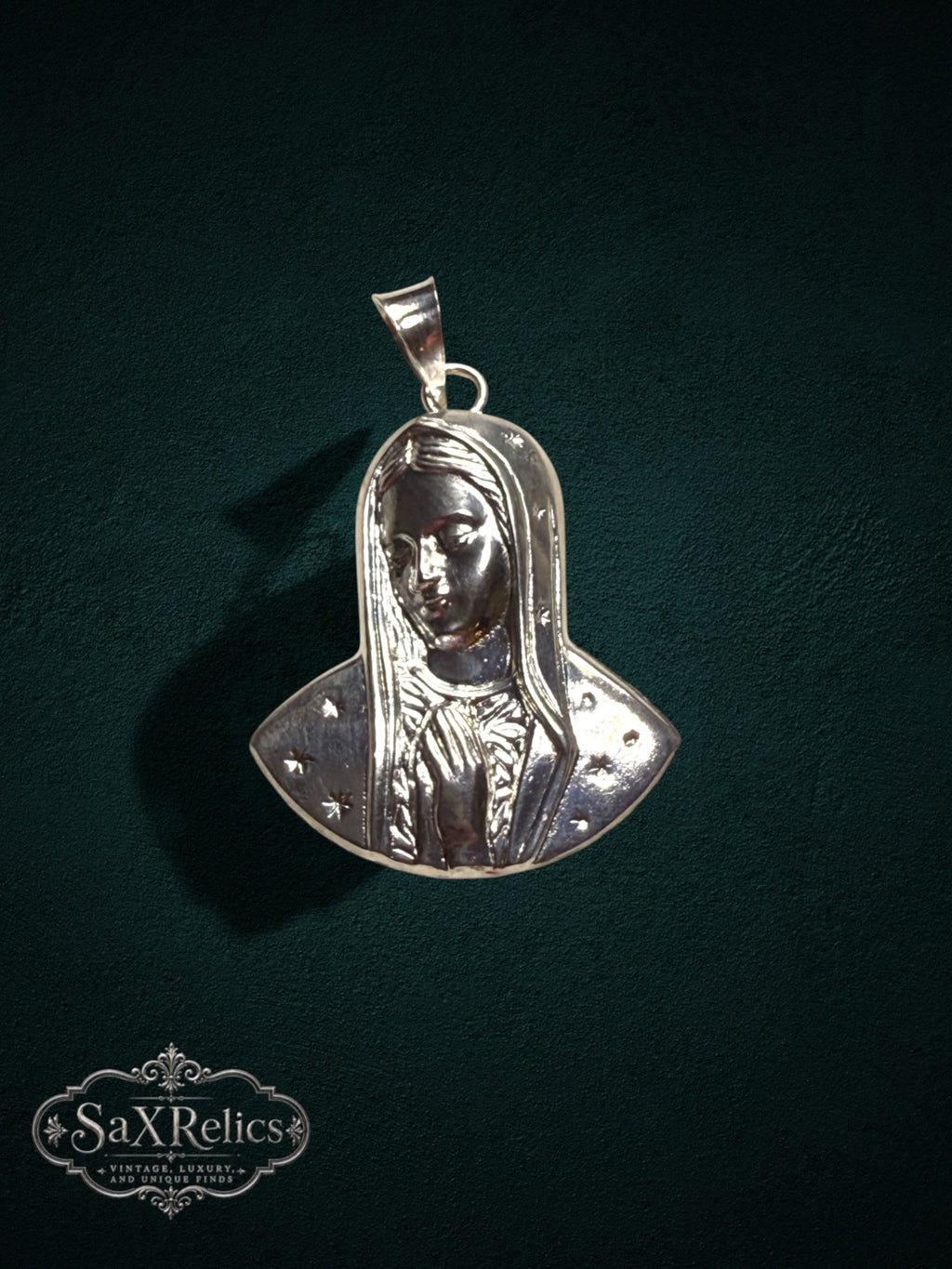 My Store SAXRelics silver Virgin Mary pendant featuring a detailed Madonna relief with delicate star accents.