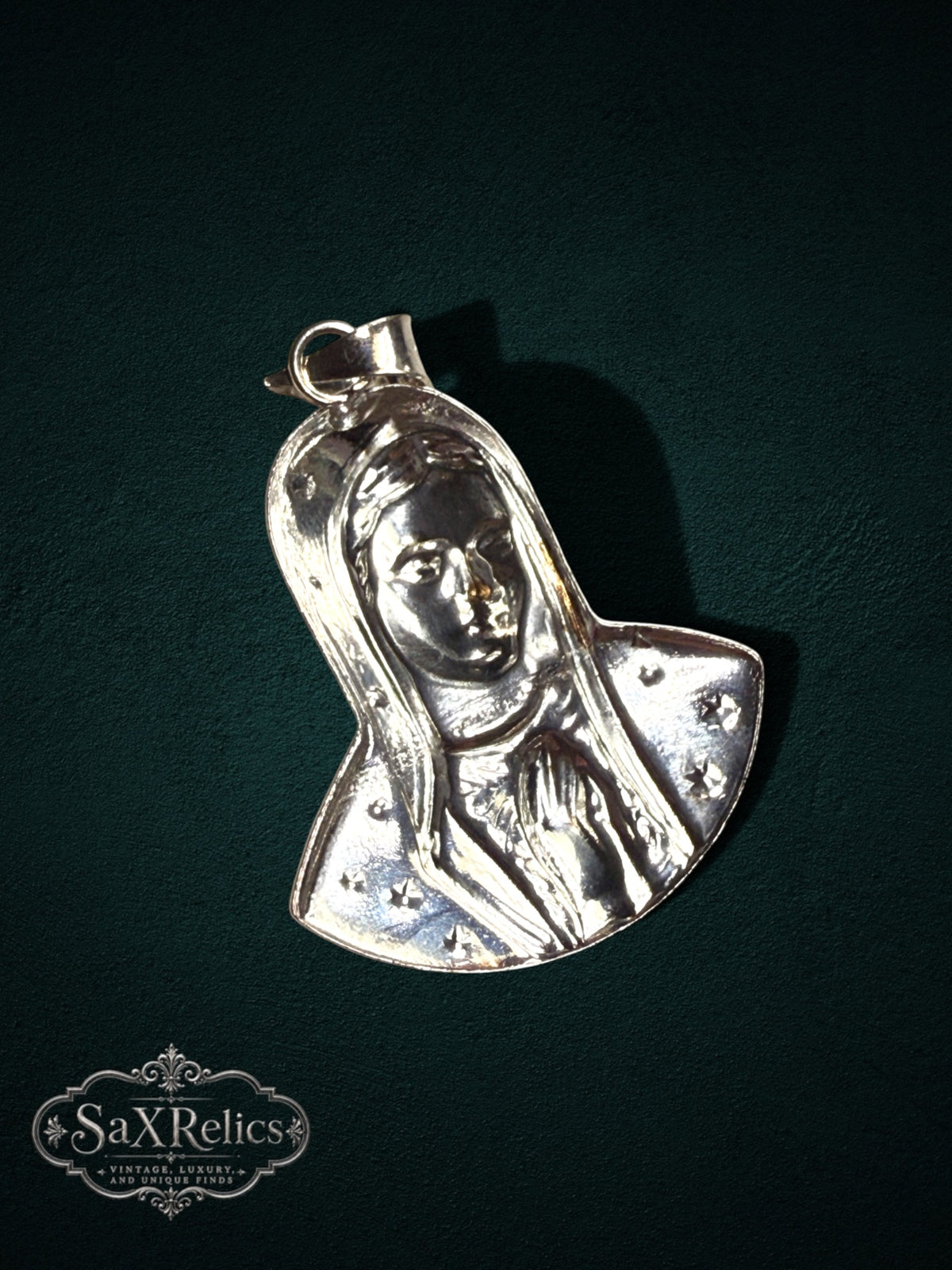 My Store silver Virgin Mary pendant featuring a detailed Madonna relief with star accents on a dark background