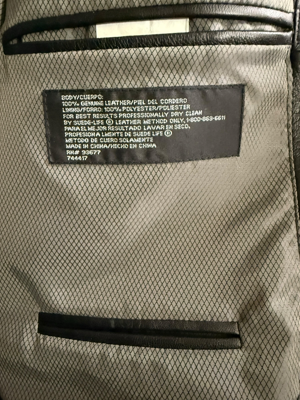 My Store Stafford genuine leather blazer interior label showing material composition and care instructions.
