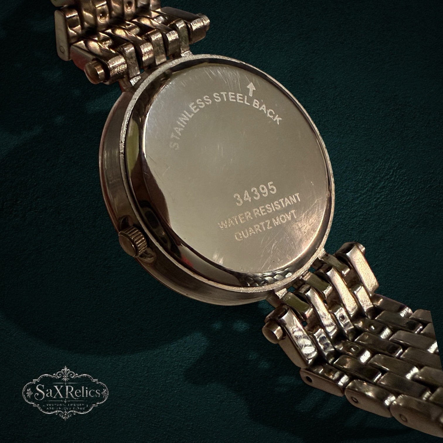 SaX Relics rose gold-tone watch showing the stainless steel caseback and link bracelet